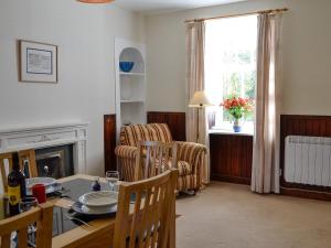 a living room with a table and chairs and a window at Prospecthill House in Whitehouse