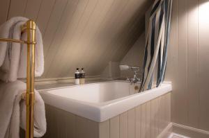 a bathroom with a white sink in a room at Flodigarry Hotel in Staffin +87 photos