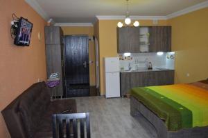 a bedroom with a bed and a kitchen at orbi plaza in Batumi +11 photos