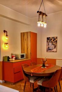 a kitchen with a dining room table and a microwave at Sicilia luxury Suite By Sattal in Bucharest