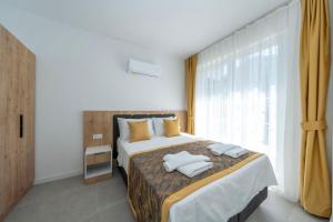 a bedroom with a bed with two pillows on it at Dede Suites Fethiye in Fethiye