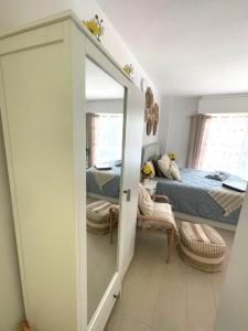 a bedroom with a bed and a mirror at Reel Apartments- Luxury Studio with swimming pool. in Torrevieja +35 photos