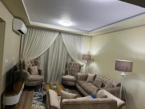 a living room with couches and a couch and chairs at marhaba madinaty 34 in Madinaty