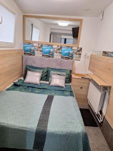 a bed in the back of a rv at Mieszkanie 3 pokoje-Faktura in Szczecinek +5 photos