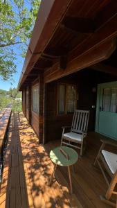 a porch of a house with a chair and a table at פסגת מתת Pisgat mattat in Mattat