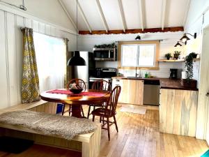 uma cozinha com mesa e cadeiras em uma sala em Chalets Village Suisse de Val-David em Val-David