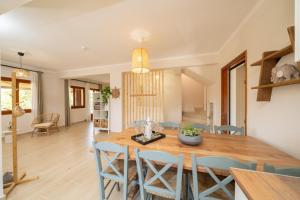 a dining room and living room with a table and chairs at Melitini's Villa in Argostoli