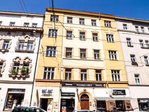 a large yellow building on a street with cars parked in front at Cozy relax Praha Letná D3 in Prague +12 photos