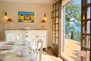 a dining room with a table and a balcony at Maison de la Rade, sea view and air conditioning in Saint-Mandrier-sur-Mer +23 photos
