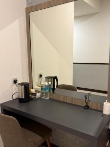 a bathroom counter with a sink and a mirror at PD DWharf Hotel Suite & Serviced Residence in Port Dickson