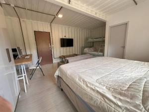 a bedroom with a bed and a desk and a computer at Casa Villela na Villela Home Stay Lago Sul in Brasilia +42 photos