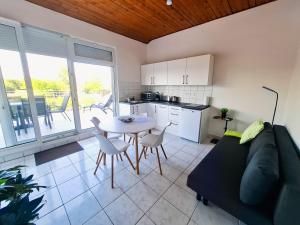 a living room with a couch and a table at PartON Keszthely in Keszthely