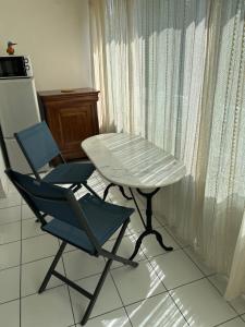 a table and two chairs in a kitchen with a table and a table at Clube 6 T1 piscine parking in La Grande-Motte