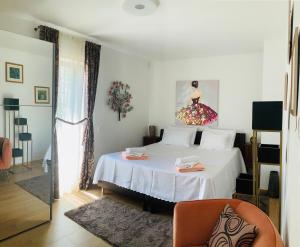 a bedroom with a white bed and a chair at Villa EVAMAR, Island Krk Punat in Punat +55 photos