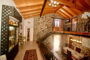 a living room with a staircase and a stone wall at Riverside - Lovely river-view 3 bedroom house in Dornes