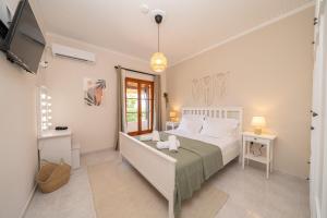 a bedroom with a bed and a tv in it at Melitini's Villa in Argostoli