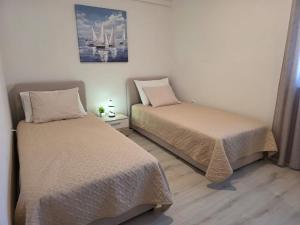 Postel nebo postele na pokoji v ubytování Lantana Apartment