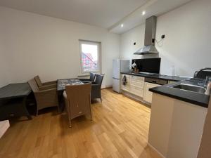 a kitchen and living room with a table and a sink at Einzelzimmer-Bad, Kühlschrank-TV-15 in Meine +3 photos