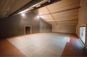 an empty room with wooden ceilings and a wooden floor at VitaNorse AB in Älglund