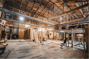 a large room with wooden ceilings and a wooden floor at VitaNorse AB in Älglund