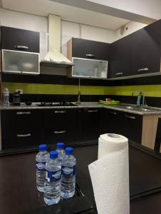 a kitchen with bottles of water on a table at Paradise in Bin Rhilouf +20 photos