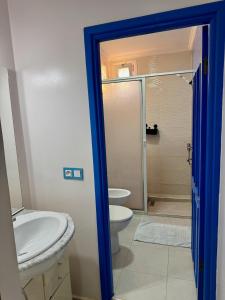 a bathroom with a toilet and a sink at La Perle De Briech in Asilah +55 photos