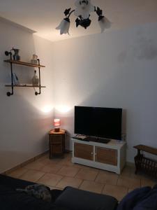 a living room with a flat screen tv on a wall at Maison de village à Riez de 87m2 in Riez