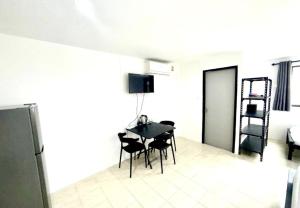 a kitchen with a table and chairs in a room at Patong Canal Villa R312 in Patong Beach
