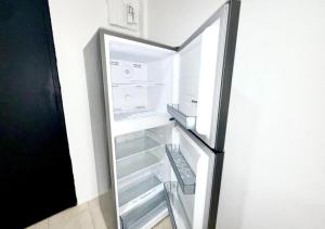 an empty refrigerator with its door open with a drawer at Patong Canal Villa R312 in Patong Beach