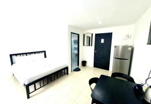 a living room with a bed and a refrigerator at Patong Canal Villa R312 in Patong Beach +10 photos