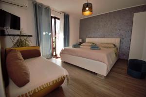 a bedroom with a bed and a couch in it at Apartments Vretenar in Novigrad Istria