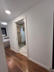 an empty room with a door and a mirror at Apartment in campello Beach in El Campello +16 photos