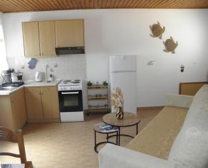 a living room with a couch and a kitchen at Angela's Nest in Chios