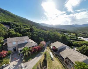 an aerial view of a house with mountains in the background at Le Relais de Sisco in Sisco
