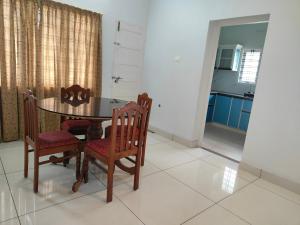 a dining room with a table and two chairs at Sankaramangalam in Trivandrum