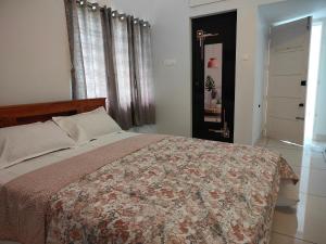 a bedroom with a bed and a window and a door at Sankaramangalam in Trivandrum