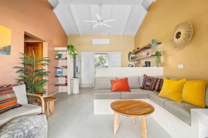 a living room with a couch and a table at Villa Happy Turtle with a spectacular ocean view in Kralendijk +37 photos