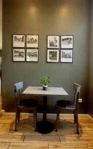 a table and chairs in a room with pictures on the wall at Al Binario Brescia in Brescia +49 photos