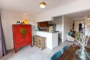 a living room with a red cabinet and a kitchen at Aqua Marina in Kralendijk