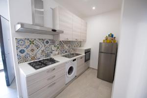 a kitchen with a stove and a refrigerator at La Trinacria in Terrasini +48 photos