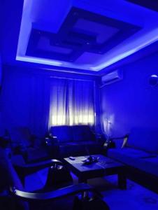 a blue room with a couch and a table at Alexandroupolis City Home Eftelya 50m City Best Location in Alexandroupoli