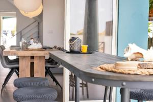 a dining table with two chairs and a table with at Casa Pimienta in Water Villas in Kralendijk