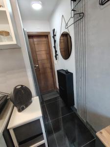 a room with a door and a table and a mirror at Compact Apartments for Solo Travelers in Igalo