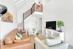ein Wohnzimmer mit Sofa und Fernseher in der Unterkunft Caribbean Court Apartment Djòdjò in Kralendijk