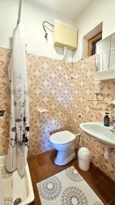 a bathroom with a toilet and a sink at Apartmani Vinka in Pisak