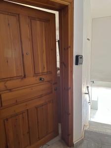 a wooden door in the corner of a room at Petreas Studio in Kardamyli