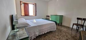 a bedroom with a bed and a green dresser at Da Zia Teresa PIAZZA 