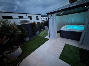 a small backyard with a bed on a patio at Apartmán Ivett in Bojnice
