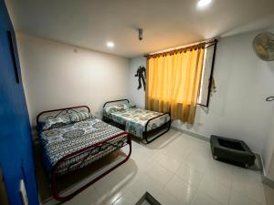 a bedroom with two beds and a window at Villa Stefy in San Antonio +33 photos