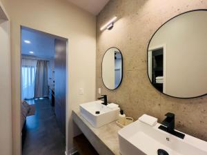 a bathroom with a white sink and a mirror at Casa Alva Suite in Valle de Guadalupe 3 BR 3 BA in Los Niños